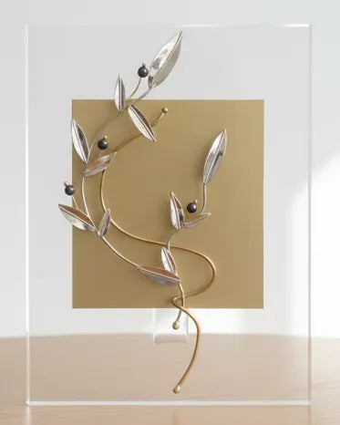 Decorative wall art with abstract design on a wooden table against a white wall