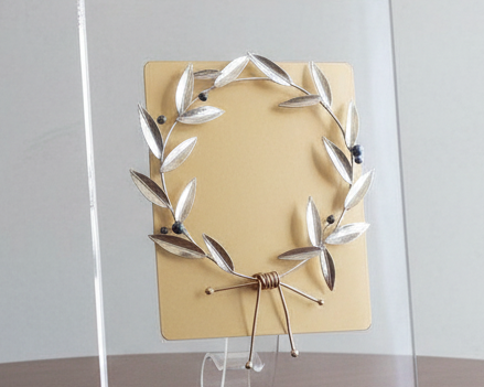 Decorative piece on a wooden table with a plain background