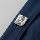 A square silver-toned pendant featuring an embossed classical bust portrait in profile, shown on a clean white background.