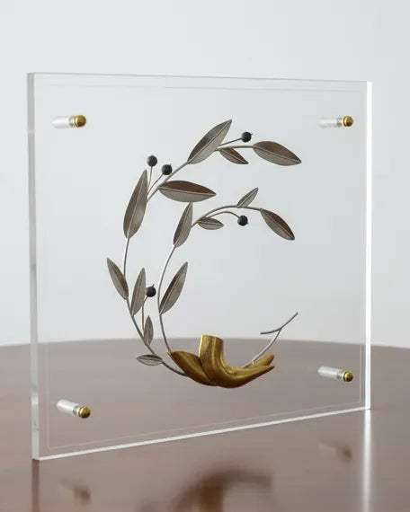 Decorative glass sculpture on a wooden table with a plain background