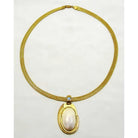 Necklace with a 18k gold medallion mother of pearl and a bleu topaz in a hand made 14k. gold chain
