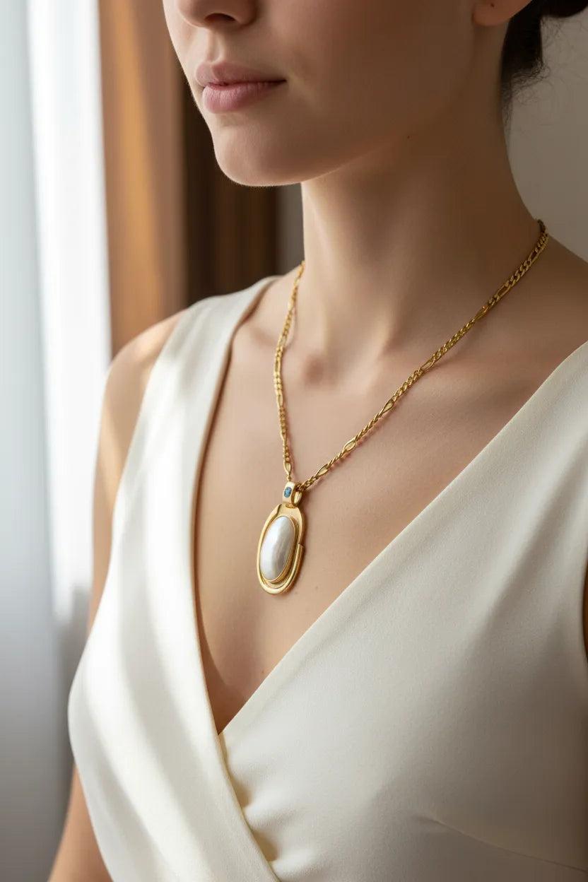 Necklace with a 18k gold medallion mother of pearl and a bleu topaz in a hand made 14k. gold chain