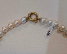Necklace with white Akoya pearls and 18k gold closure